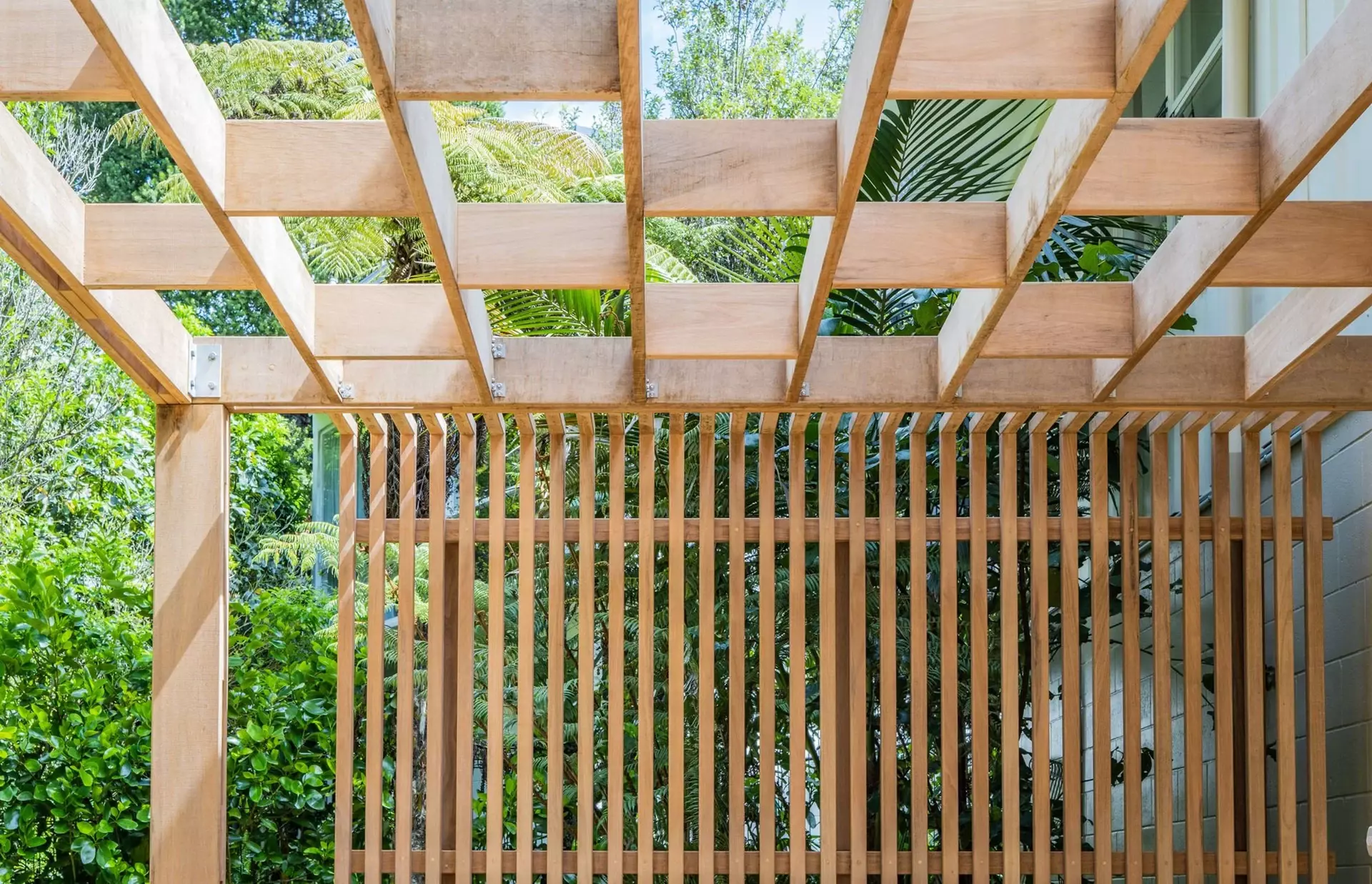 Detail of pergola stagged design and timber privacy fence