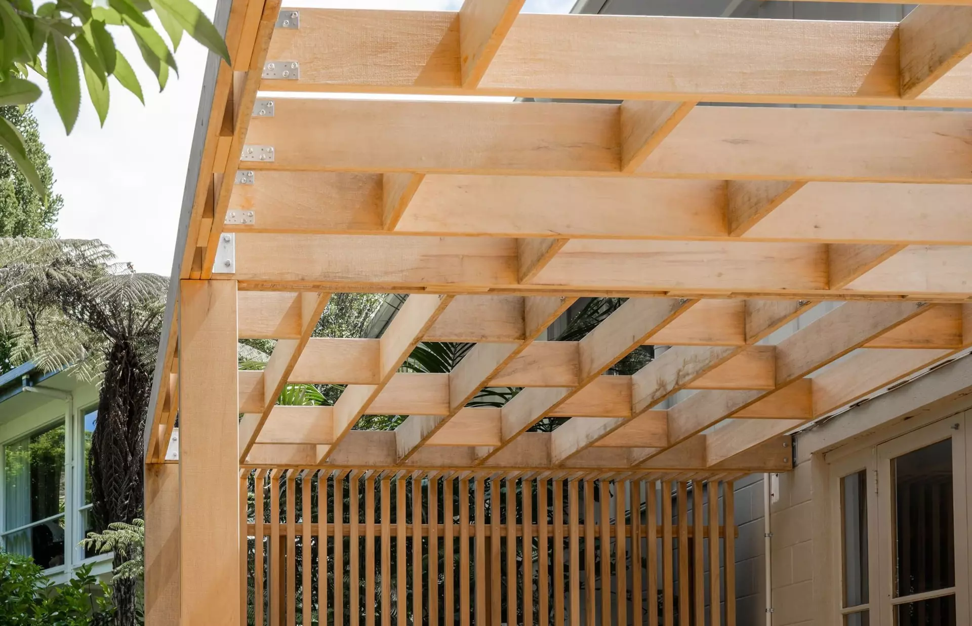 Unique timber pergola design intergrated into privacy fence