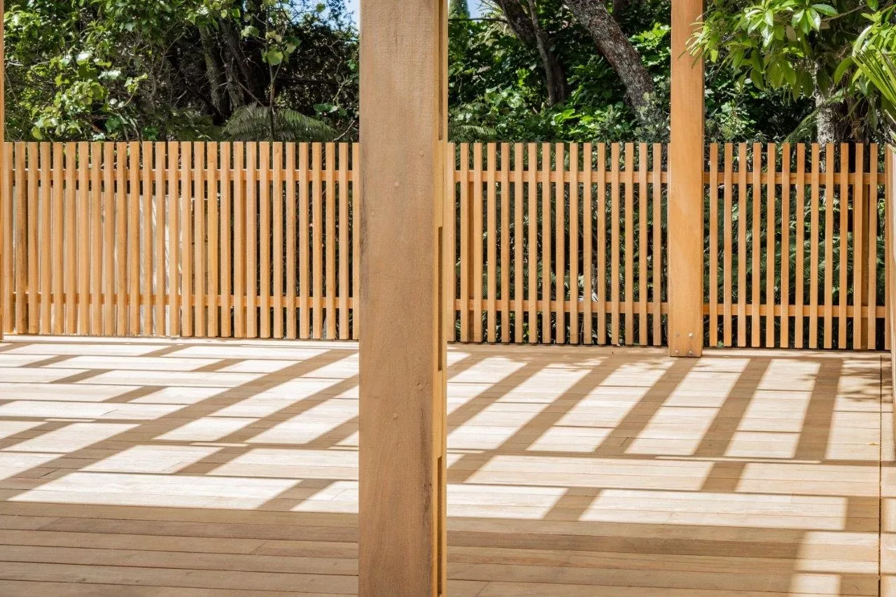 Timber Deck with timber posts for pergola and lattice fencing in the background
