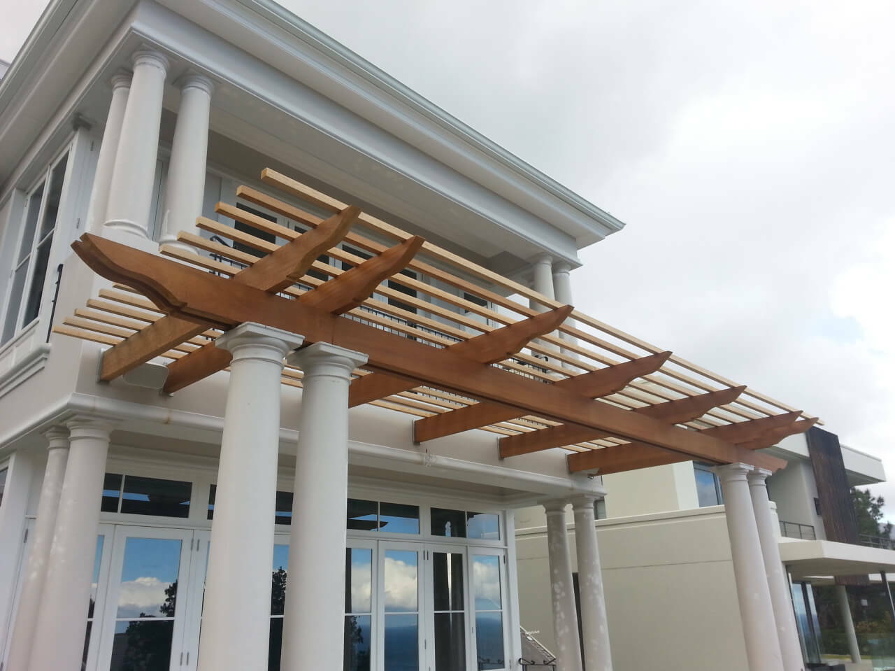 Timber pergola on white house