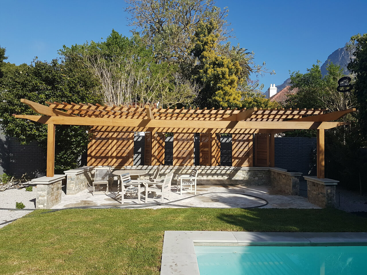 Pergola next to pool